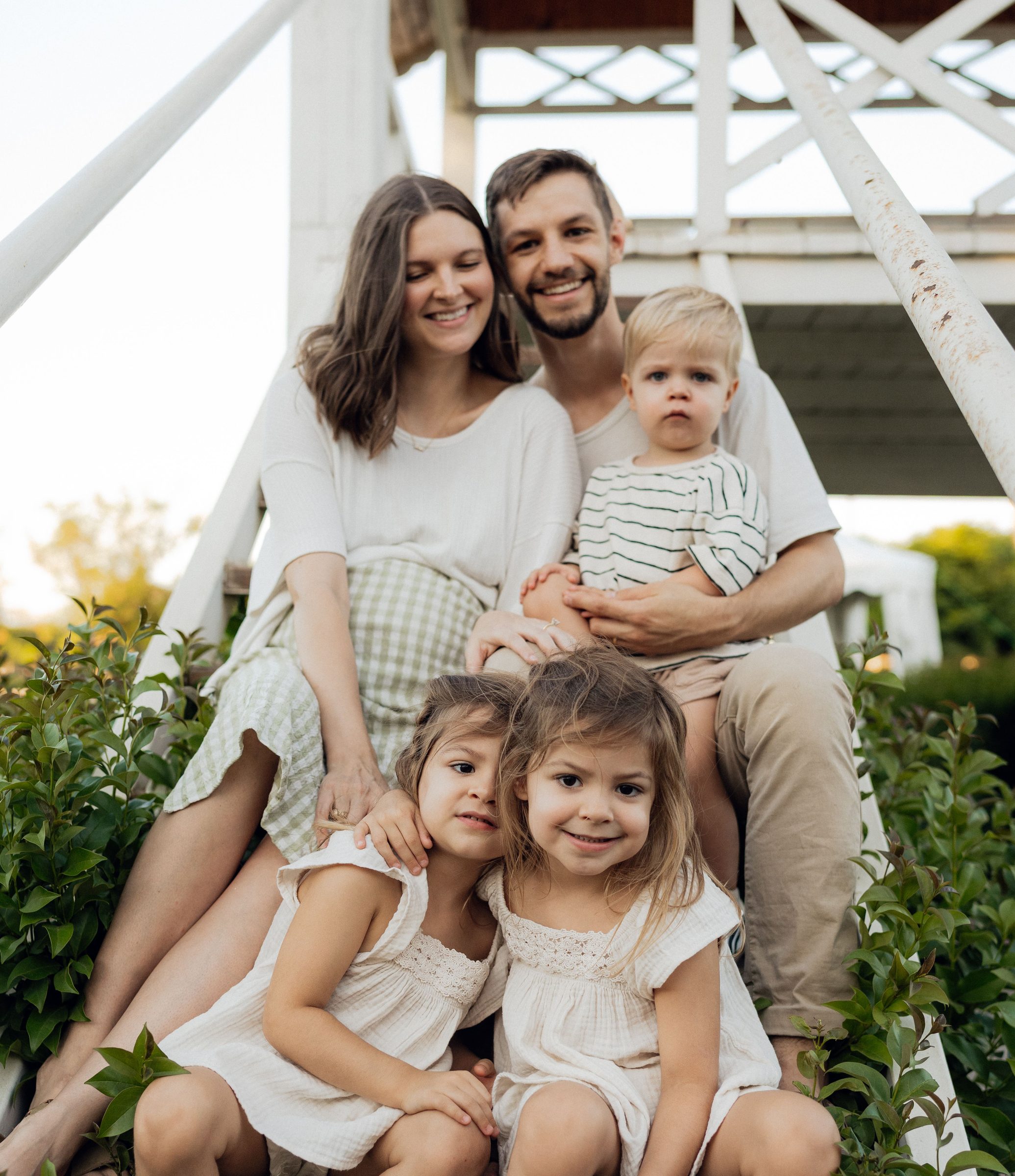 Smiling family sitting together on outdoor steps
